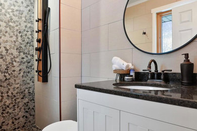 Inspiration for a mid-sized modern 3/4 gray tile and mosaic tile ceramic tile, beige floor and single-sink bathroom remodel in Minneapolis with flat-panel cabinets, white cabinets, beige walls, a drop-in sink, granite countertops, black countertops and a freestanding vanity
