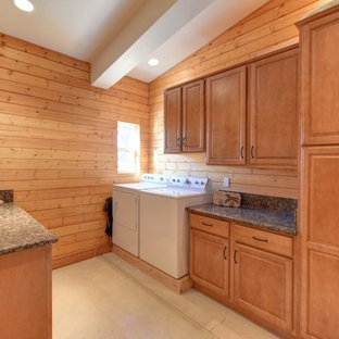 Expansive country utility room in Sacramento with raised-panel cabinets, medium wood cabinets, granite worktops, brown walls, concrete flooring, a side by side washer and dryer and beige floors.