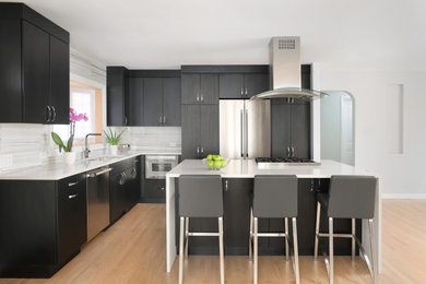 Example of a small minimalist l-shaped light wood floor eat-in kitchen design in Chicago with an undermount sink, flat-panel cabinets, black cabinets, quartz countertops, white backsplash, porcelain backsplash, stainless steel appliances, an island and white countertops