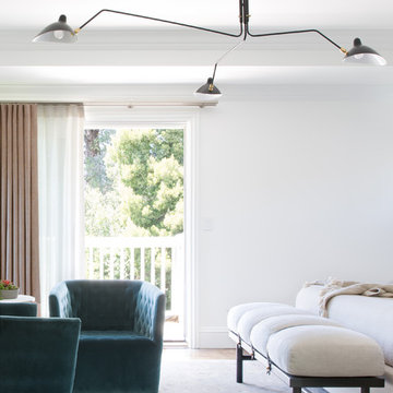 Primary Bedroom with Mid-Century–Inspired Lighting and Soft Neutrals