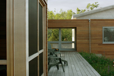 Mid-sized contemporary one-storey brown exterior in Portland Maine with wood siding.