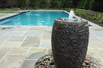 Large trendy backyard tile and rectangular lap pool fountain photo in DC Metro