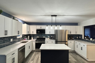Example of a mid-sized transitional u-shaped eat-in kitchen design in Chicago with shaker cabinets, white cabinets, quartz countertops, blue backsplash, an island and white countertops