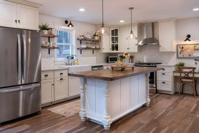 Kitchen - kitchen idea in Other with a farmhouse sink, yellow backsplash, subway tile backsplash and white countertops