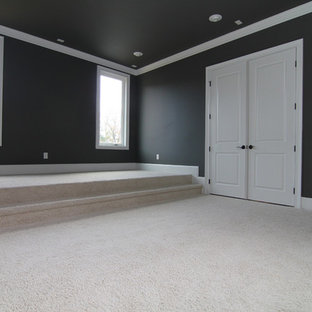 This is an example of a large classic enclosed home cinema in Raleigh with grey walls, carpet and a wall mounted tv.