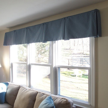 Box pleat valances enhanced with covered buttons in a quiet study