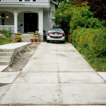 Clean Concrete Drive with Bold Brick Accents