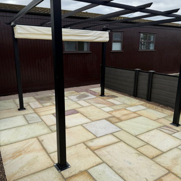 Sandstone Paving Set Around Steel Pergola Posts