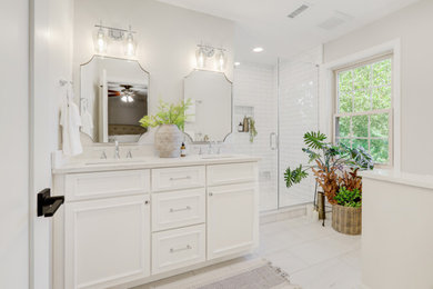 Alcove shower - large contemporary master marble floor, white floor and double-sink alcove shower idea in Other with recessed-panel cabinets, white cabinets, a two-piece toilet, white walls, an undermount sink, quartz countertops, a hinged shower door, white countertops, a niche and a built-in vanity