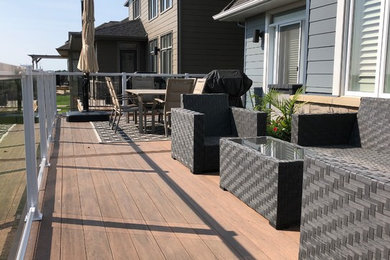 Design ideas for a mid-sized contemporary backyard deck in Ottawa with no cover.