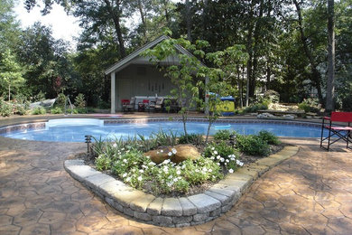 Example of a large classic backyard custom-shaped pool design in Wilmington