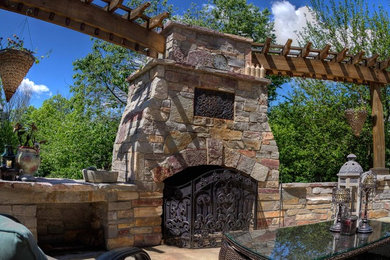 Inspiration for a rustic concrete patio remodel in Other with a fire pit and a pergola