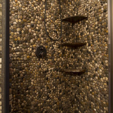 Pebble walls and floor log home shower