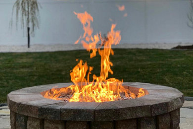 Photo of a mid-sized traditional backyard landscaping in Denver with a fire pit.