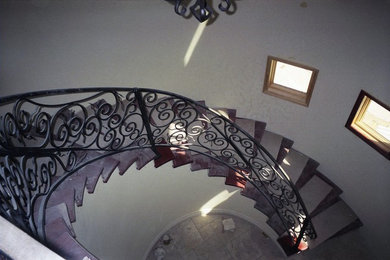 Staircase - large mediterranean wooden spiral staircase idea in Phoenix with wooden risers