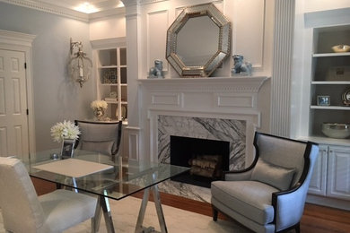 Example of a mid-sized classic freestanding desk medium tone wood floor study room design in Raleigh with white walls, a standard fireplace and a stone fireplace