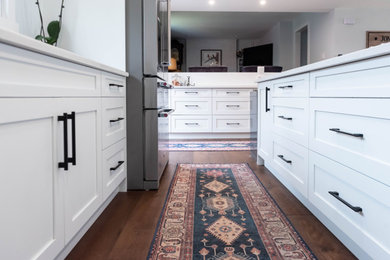 Inspiration for a mid-sized contemporary single-wall eat-in kitchen remodel in Calgary with an undermount sink, shaker cabinets, white cabinets, quartzite countertops, stainless steel appliances, an island and white countertops