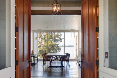 Photo of a mid-sized country foyer in Other with a double front door, medium hardwood floors, a medium wood front door and brown floor.