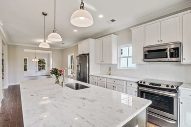 Eat-in kitchen - mid-sized transitional single-wall dark wood floor eat-in kitchen idea in Charleston with a single-bowl sink, shaker cabinets, white cabinets, granite countertops, white backsplash, subway tile backsplash, stainless steel appliances and an island
