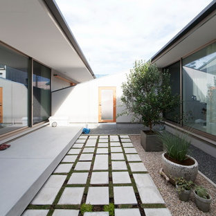 他の地域のモダンスタイルのおしゃれな中庭のテラス (天然石敷き、張り出し屋根) の写真