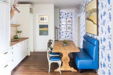 Inspiration for a mid-sized farmhouse light wood floor enclosed dining room remodel in Other with multicolored walls