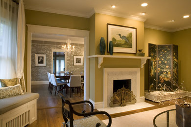 Living room - mid-sized transitional enclosed medium tone wood floor living room idea in Chicago with green walls, a standard fireplace and a stone fireplace