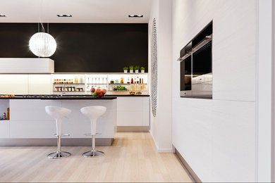 Photo of a large contemporary galley open plan kitchen in Milan with an integrated sink, louvered cabinets, light wood cabinets, quartz benchtops, glass sheet splashback, stainless steel appliances, light hardwood floors and with island.