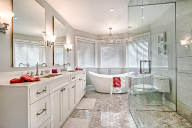 Bathroom - mid-sized traditional master multicolored tile and marble tile marble floor, white floor and double-sink bathroom idea in Vancouver with shaker cabinets, white cabinets, a one-piece toilet, gray walls, an undermount sink, quartz countertops, a hinged shower door, white countertops, a niche and a built-in vanity