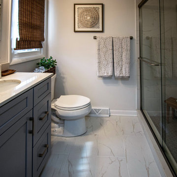 Gray Bathroom with Tiled Shower and Make-Up Area