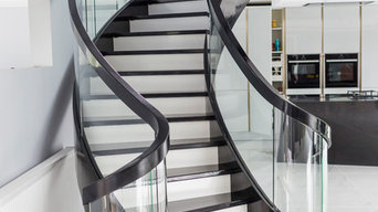 black and white curved stairs with glass balustrade