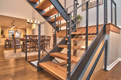 Staircase - transitional floating cable railing staircase idea in Other