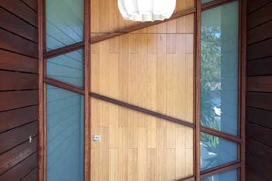 Single front door - mid-sized modern single front door idea in Los Angeles with a light wood front door