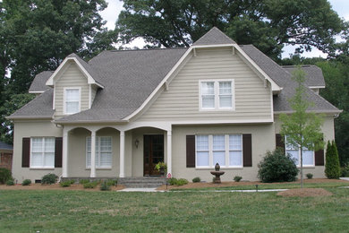 Mid-sized traditional gray two-story mixed siding house exterior idea in Charlotte with a hip roof and a shingle roof