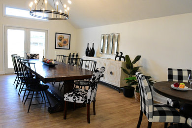 Inspiration for a large country vinyl floor, brown floor and vaulted ceiling dining room remodel in Philadelphia with white walls, a standard fireplace and a brick fireplace