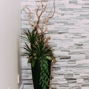 Design ideas for a large modern home office and library in Edmonton with grey walls, ceramic flooring and a hanging fireplace.