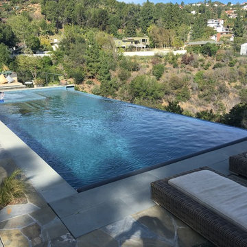 Infinity pool and spa with automatic pool cover