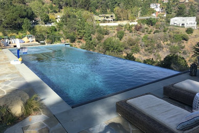 Hot tub - large contemporary backyard tile and rectangular infinity hot tub idea in Los Angeles
