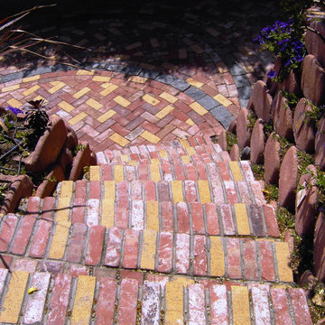 Front Yard with Artistic Driveway, Custom Sculptures, Planted Walls