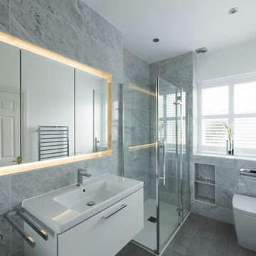 Grey Marble Luxury En Suite with Bespoke Illuminating Recess featuring Mirrors.
