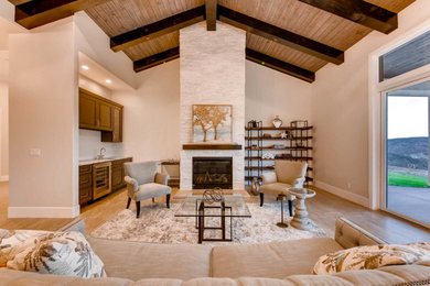 Open concept beige floor living room photo in Orange County with a bar, beige walls, no tv, a ribbon fireplace and a stone fireplace