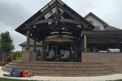 Large arts and crafts backyard patio kitchen photo in Wichita with decking and a roof extension