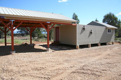 Example of a mid-sized minimalist gray one-story wood exterior home design in Denver with a hip roof