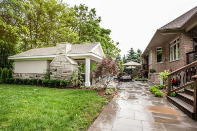 Design ideas for a transitional backyard stone water fountain landscape in Toronto.