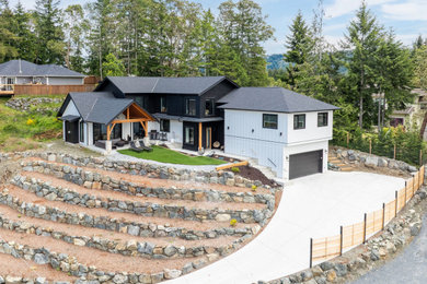 Inspiration for a large contemporary multicolored two-story mixed siding and board and batten exterior home remodel in Vancouver with a shingle roof and a black roof