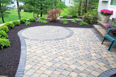 Mid-sized classic concrete paver back porch idea in Philadelphia