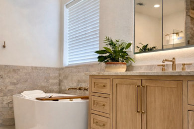 Large transitional master beige tile and marble tile porcelain tile, gray floor and double-sink bathroom photo in Dallas with shaker cabinets, light wood cabinets, a bidet, beige walls, an undermount sink, quartzite countertops, a hinged shower door, beige countertops, a niche and a built-in vanity