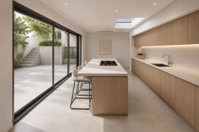 Photo of a grey and brown single-wall open plan kitchen in London with an integrated sink, medium wood cabinets, marble worktops, white splashback, integrated appliances, an island, grey floors, grey worktops and feature lighting.