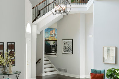 Inspiration for a large transitional dark wood floor entryway remodel in Minneapolis with gray walls and a white front door