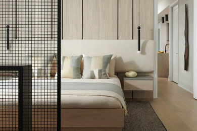 Inspiration for a large scandinavian master light wood floor and wood wall bedroom remodel in Toronto with white walls