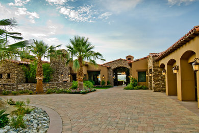 Large southwest brown two-story mixed siding exterior home photo in Other with a tile roof
